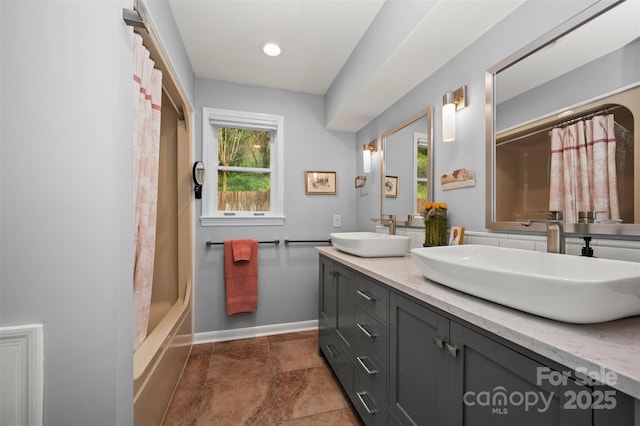 44 Jervey Rd Unit 3A, Tryon, NC 28782 - bathroom with double vanity, baseboards, and shower / bathtub combination with curtain