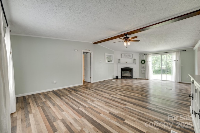 284 Cedar Grove Rd, Clover, SC 29710 - unfurnished living room with ceiling fan, a fireplace, wood finished floors, a textured ceiling, and baseboards