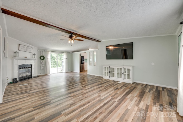 284 Cedar Grove Rd, Clover, SC 29710 - unfurnished living room featuring a textured ceiling, a ceiling fan, wood finished floors, a glass covered fireplace, and baseboards