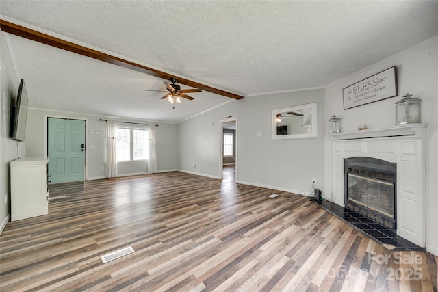 284 Cedar Grove Rd, Clover, SC 29710 - unfurnished living room featuring a glass covered fireplace, a ceiling fan, wood finished floors, a textured ceiling, and baseboards