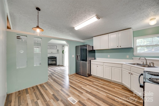 284 Cedar Grove Rd, Clover, SC 29710 - kitchen with stainless steel refrigerator with ice dispenser, electric stove, a sink, white cabinetry, and ornamental molding