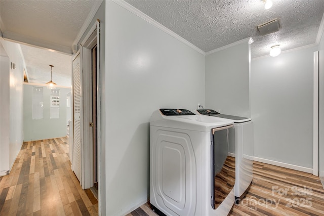 284 Cedar Grove Rd, Clover, SC 29710 - laundry area with washing machine and clothes dryer, light wood finished floors, a textured ceiling, ornamental molding, and baseboards