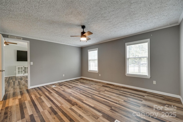 284 Cedar Grove Rd, Clover, SC 29710 - empty room with a ceiling fan, crown molding, wood finished floors, baseboards, and a textured ceiling