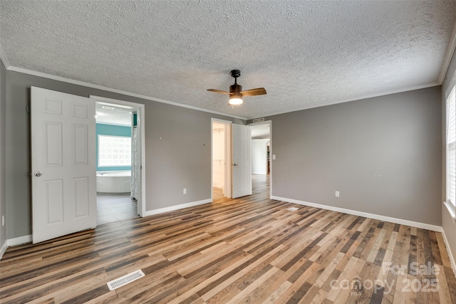 284 Cedar Grove Rd, Clover, SC 29710 - unfurnished bedroom with crown molding, baseboards, wood finished floors, a textured ceiling, and ensuite bathroom