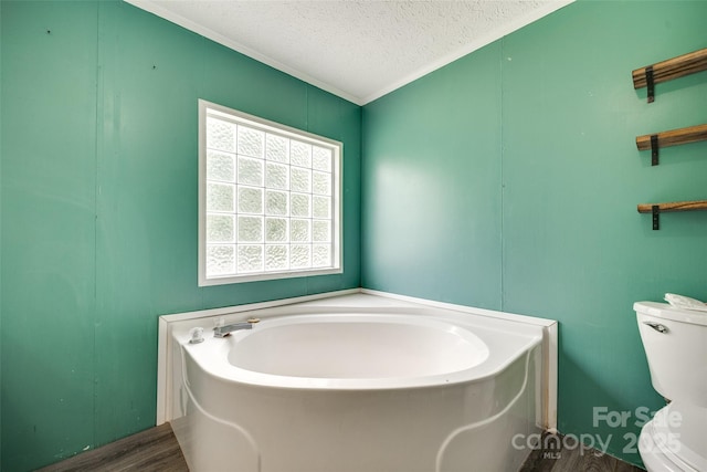 284 Cedar Grove Rd, Clover, SC 29710 - full bathroom with a garden tub, toilet, ornamental molding, a textured ceiling, and wood finished floors
