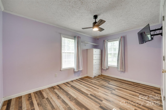 284 Cedar Grove Rd, Clover, SC 29710 - unfurnished bedroom featuring crown molding, light wood-type flooring, multiple windows, a textured ceiling, and baseboards