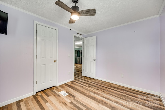 284 Cedar Grove Rd, Clover, SC 29710 - unfurnished bedroom with light wood-type flooring, a textured ceiling, baseboards, a ceiling fan, and ornamental molding