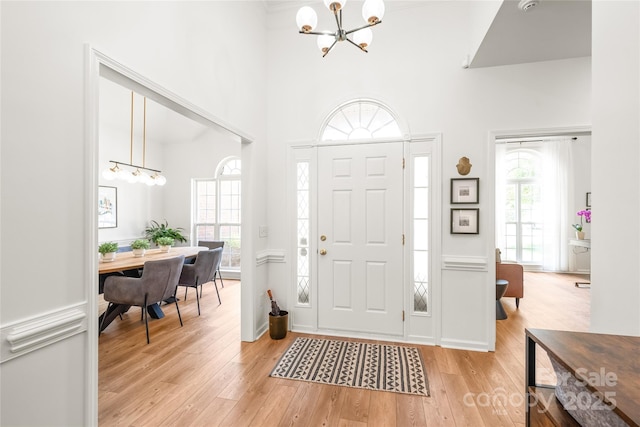 502 Roxanne Ct NW, Concord, NC 28027 - entrance foyer with a chandelier, light wood-type flooring, and a high ceiling