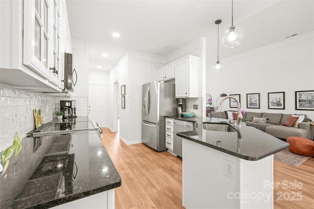 502 Roxanne Ct NW, Concord, NC 28027 - kitchen with a sink, appliances with stainless steel finishes, backsplash, white cabinets, and crown molding