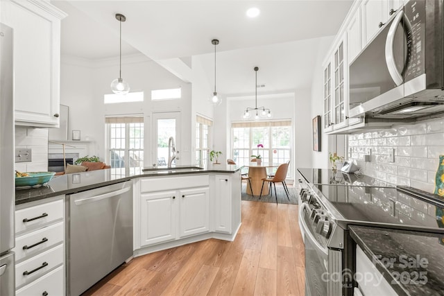 502 Roxanne Ct NW, Concord, NC 28027 - kitchen with appliances with stainless steel finishes, a sink, white cabinets, decorative backsplash, and recessed lighting