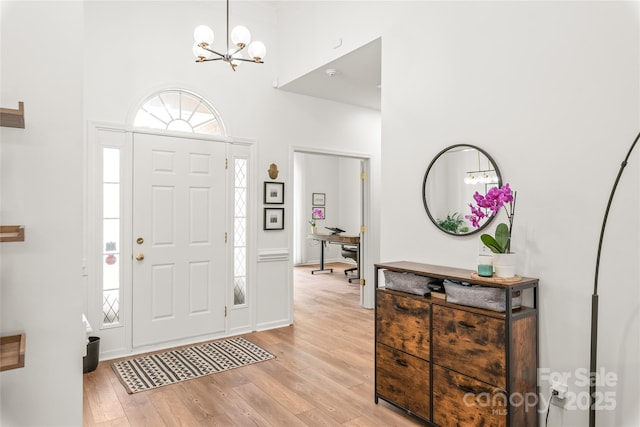 502 Roxanne Ct NW, Concord, NC 28027 - foyer with a towering ceiling, light wood-style flooring, and a chandelier