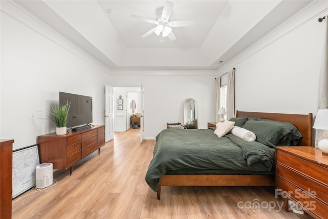 502 Roxanne Ct NW, Concord, NC 28027 - bedroom with light wood-style floors, a tray ceiling, and a ceiling fan