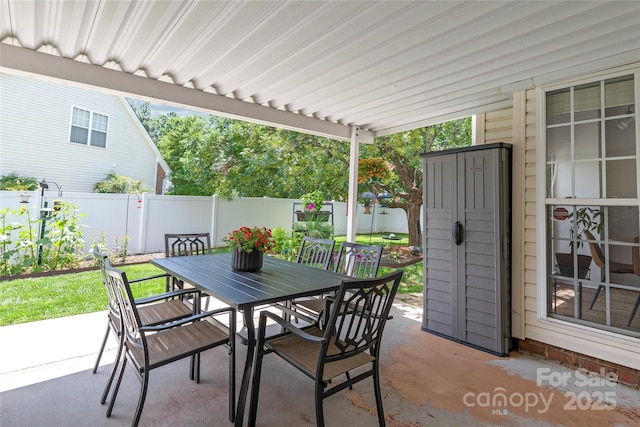 502 Roxanne Ct NW, Concord, NC 28027 - fenced backyard featuring outdoor dining area and a patio