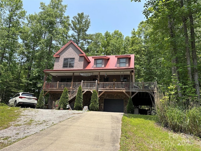 76 Six Springs Rd, Spruce Pine, NC 28777 - view of front of house with driveway, stone siding, a garage, and a metal roof