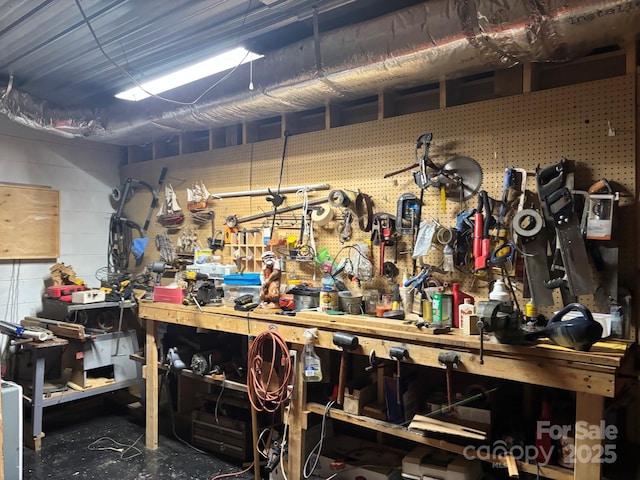 76 Six Springs Rd, Spruce Pine, NC 28777 - misc room featuring a workshop area, concrete block wall, and concrete floors
