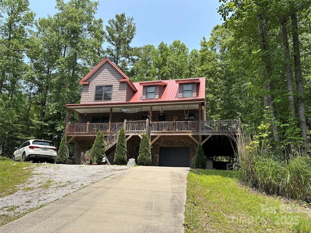 76 Six Springs Rd, Spruce Pine, NC 28777 - view of front of house featuring an attached garage, driveway, stone siding, covered porch, and stairway
