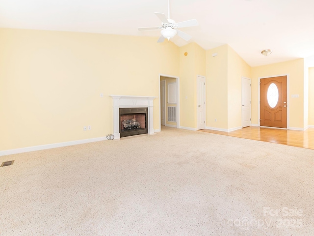 1271 Applewood Ln, York, SC 29745 - unfurnished living room featuring carpet flooring, a fireplace with flush hearth, baseboards, a ceiling fan, and high vaulted ceiling