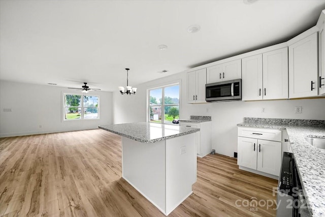 1600/1602 Bluff St, Albemarle, NC 28001 - kitchen featuring stainless steel microwave, plenty of natural light, a chandelier, and open floor plan