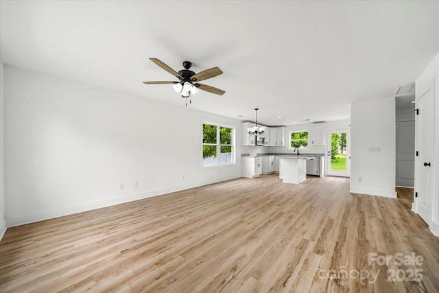 1600/1602 Bluff St, Albemarle, NC 28001 - unfurnished living room with ceiling fan, light wood-type flooring, baseboards, and a chandelier