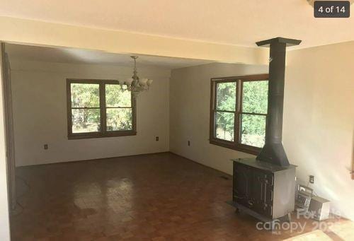 168 Pleasant Creek Dr, Cleveland, NC 27013 - unfurnished dining area with a wood stove, healthy amount of natural light, and a chandelier