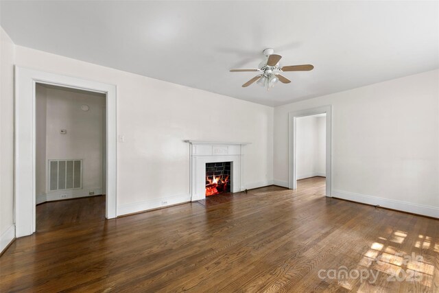 505 Franklin Ave, Shelby, NC 28150 - unfurnished living room featuring ceiling fan, a fireplace with flush hearth, wood finished floors, and baseboards