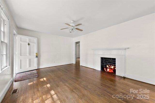 505 Franklin Ave, Shelby, NC 28150 - unfurnished living room featuring ceiling fan, wood finished floors, a fireplace, and baseboards