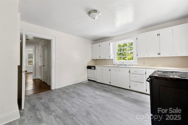 505 Franklin Ave, Shelby, NC 28150 - kitchen with black stove, white dishwasher, a sink, light countertops, and light wood-style floors