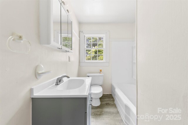505 Franklin Ave, Shelby, NC 28150 - full bath with toilet, vanity, wood finished floors, and bathtub / shower combination