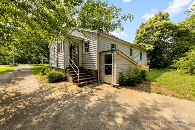 505 Franklin Ave, Shelby, NC 28150 - view of front of house with concrete driveway and a chimney
