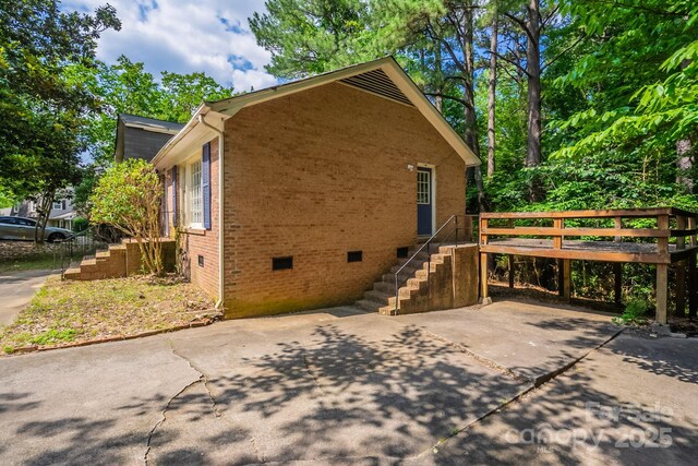 7320 Ritter Dr, Charlotte, NC 28270 - view of side of home featuring crawl space, brick siding, stairs, a wooden deck, and a patio area