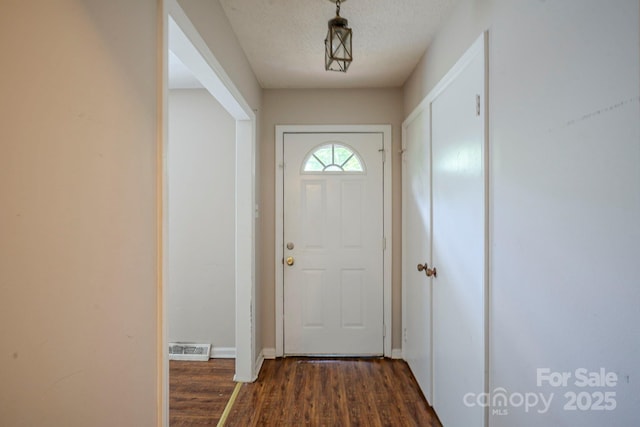 7320 Ritter Dr, Charlotte, NC 28270 - entryway featuring dark wood finished floors and a textured ceiling