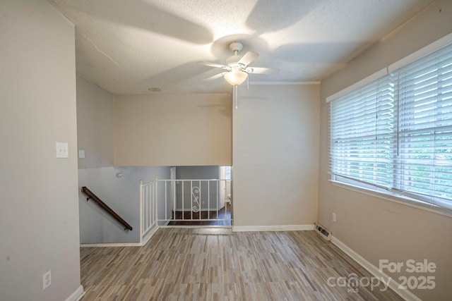 7320 Ritter Dr, Charlotte, NC 28270 - spare room featuring wood finished floors, a textured ceiling, and ceiling fan