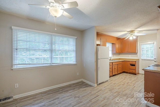 7320 Ritter Dr, Charlotte, NC 28270 - kitchen with freestanding refrigerator, ceiling fan, light wood-style floors, a textured ceiling, and light countertops