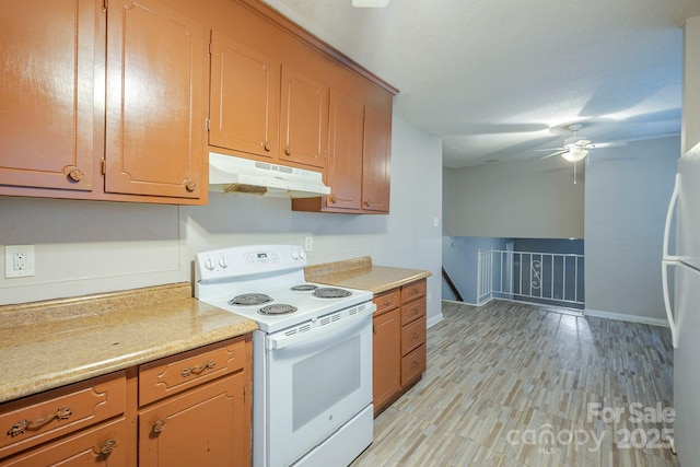 7320 Ritter Dr, Charlotte, NC 28270 - kitchen with white appliances, under cabinet range hood, light countertops, ceiling fan, and light wood-style floors