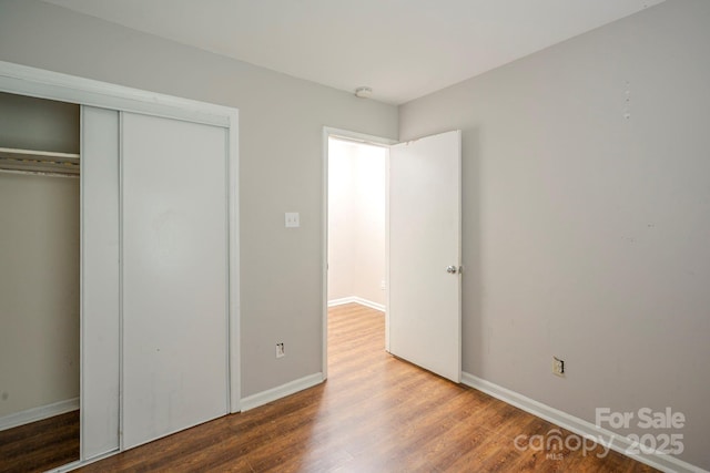 7320 Ritter Dr, Charlotte, NC 28270 - unfurnished bedroom with wood finished floors and a closet