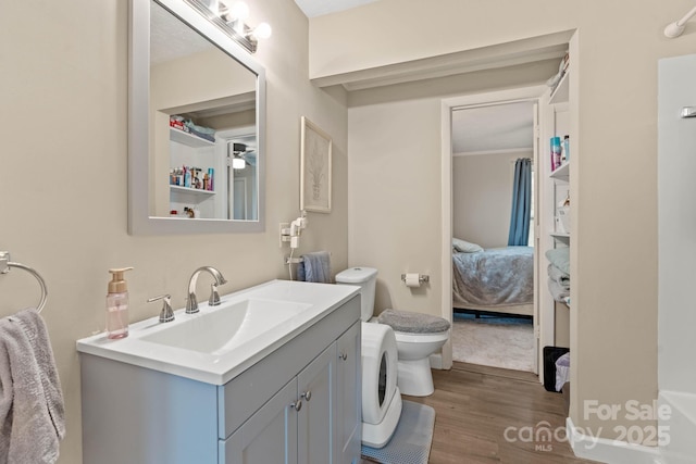 1425 3rd Street Pl NE, Hickory, NC 28601 - ensuite bathroom with wood finished floors, vanity, toilet, and washer / dryer