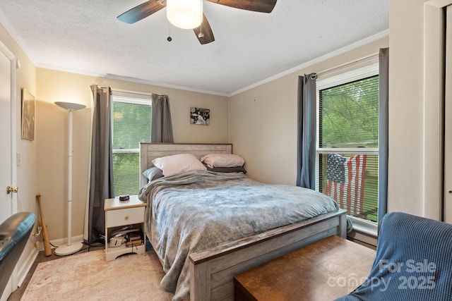 1425 3rd Street Pl NE, Hickory, NC 28601 - bedroom featuring a textured ceiling, ornamental molding, a ceiling fan, baseboards, and light carpet