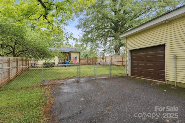 1425 3rd Street Pl NE, Hickory, NC 28601 - view of yard with a garage, asphalt driveway, and a gate