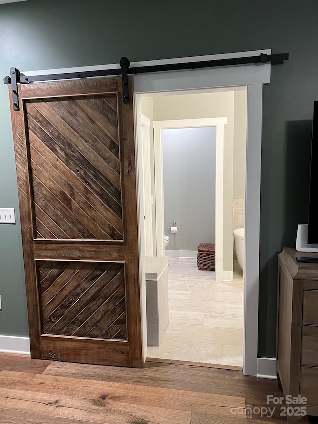49 S Sundrops Trl, Cullowhee, NC 28723 - detailed view of a barn door, baseboards, and wood finished floors