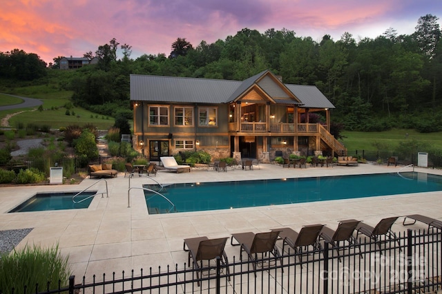 49 S Sundrops Trl, Cullowhee, NC 28723 - rear view of property featuring a patio, a community pool, stone siding, and a metal roof
