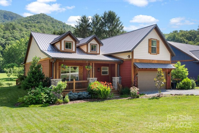 49 S Sundrops Trl, Cullowhee, NC 28723 - view of front of home with covered porch, an attached garage, a front lawn, driveway, and a metal roof