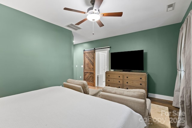 49 S Sundrops Trl, Cullowhee, NC 28723 - bedroom featuring wood finished floors, a barn door, ceiling fan, and ensuite bathroom