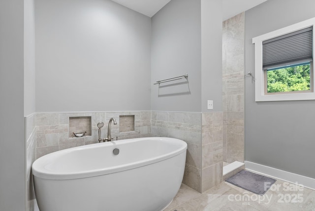 49 S Sundrops Trl, Cullowhee, NC 28723 - bathroom featuring a freestanding bath, a tile shower, and tile walls