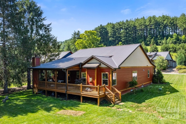 49 S Sundrops Trl, Cullowhee, NC 28723 - rear view of house featuring a lawn, a chimney, a deck, and a metal roof