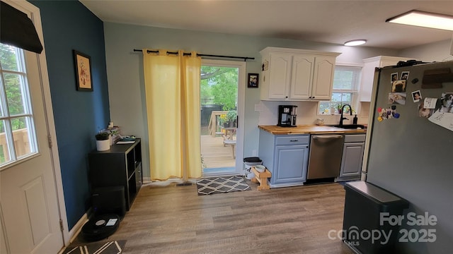 10 Haven Crest Ln, Fletcher, NC 28732 - kitchen featuring appliances with stainless steel finishes, a sink, wooden counters, white cabinets, and wood finished floors