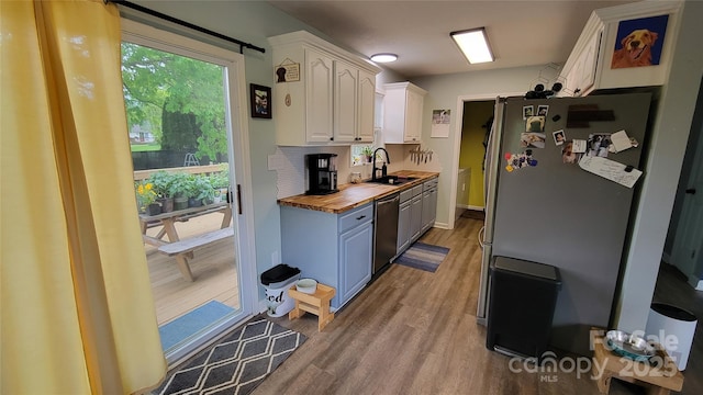 10 Haven Crest Ln, Fletcher, NC 28732 - kitchen with stainless steel appliances, butcher block countertops, white cabinetry, light wood-type flooring, and a sink