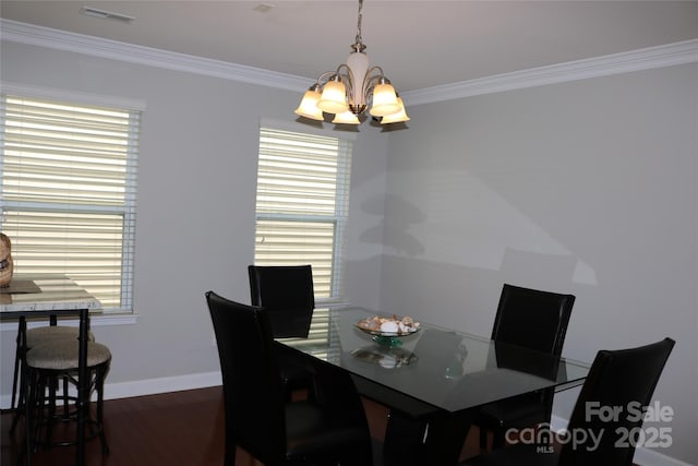 10726 Greenhead View Rd, Charlotte, NC 28262 - dining room with a chandelier, ornamental molding, and dark wood-style flooring