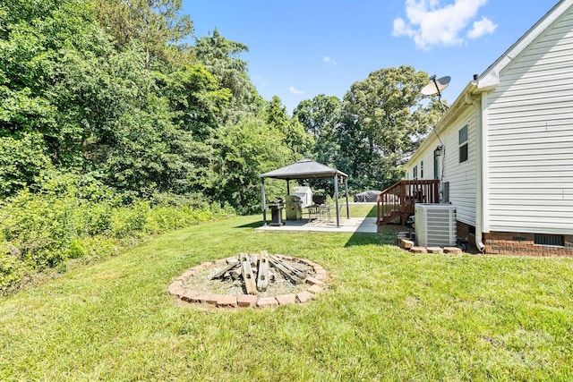 118 Grain Dr, Stony Point, NC 28678 - view of grassy yard with central air condition unit, a gazebo, an outdoor fire pit, and a patio area
