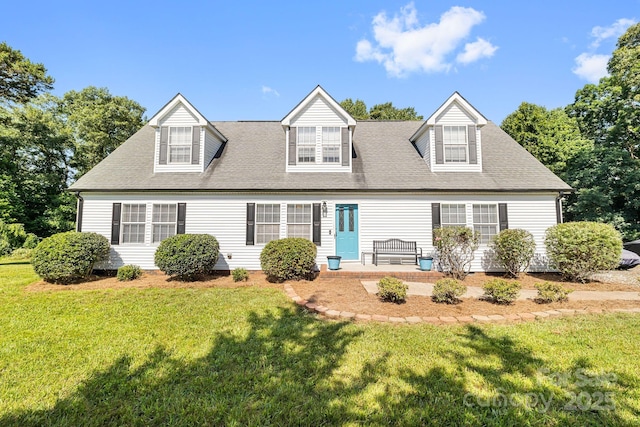 118 Grain Dr, Stony Point, NC 28678 - cape cod-style house with a front lawn, roof with shingles, and a patio area