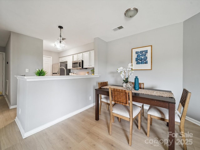 18817 Nautical Dr Unit 302, Cornelius, NC 28031 - dining room featuring light wood finished floors and baseboards